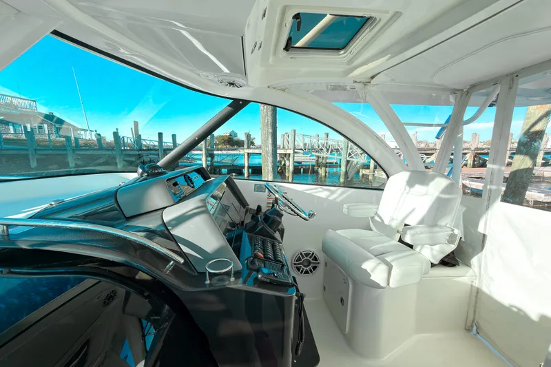 Slide: The Image of Interior view of 2021 Pursuit OS 385 Offshore boat cockpit with modern controls and seating. - 34