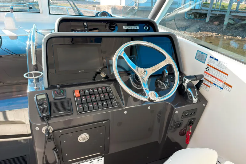 Slide: The Image of Helm of 2021 Pursuit OS 385 Offshore boat with modern controls and steering wheel. - 35