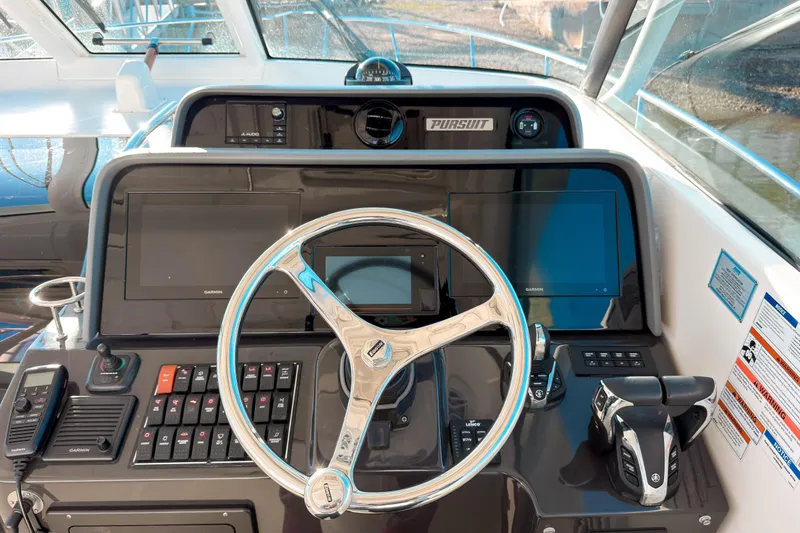 Slide: The Image of 2021 Pursuit OS 385 Offshore helm with modern controls and Garmin displays. - 36