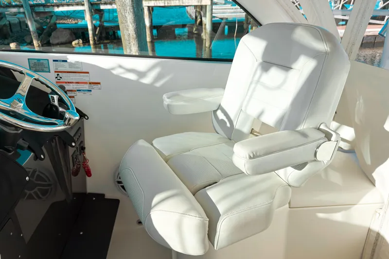 Slide: The Image of Captain's chair and helm of 2021 Pursuit OS 385 Offshore boat. - 37