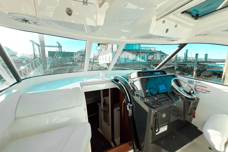 Slide: The Image of Interior view of a 2021 Pursuit OS 385 Offshore boat cockpit with modern controls. - 39