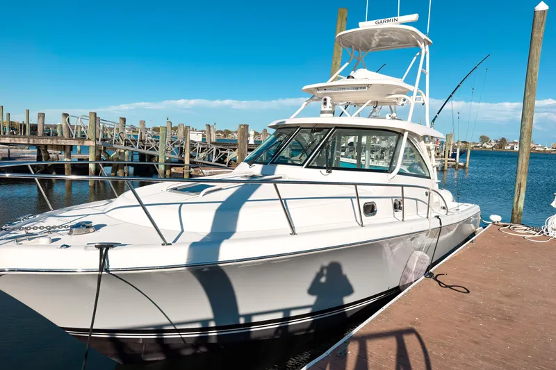 Slide: The Image of 2021 Pursuit OS 385 Offshore boat docked at marina under clear blue sky. - 4