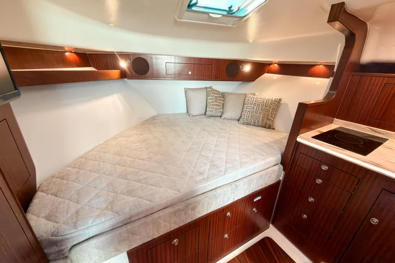 Slide: The Image of Luxurious cabin interior of 2021 Pursuit OS 385 Offshore boat with cozy bedding. - 42
