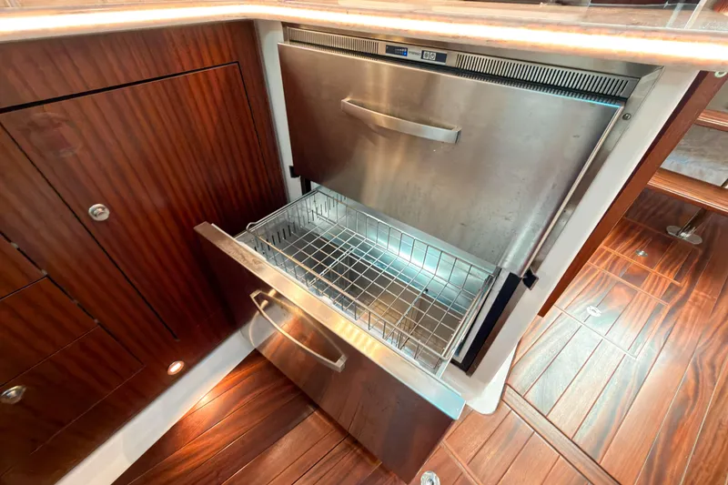 Slide: The Image of 2021 Pursuit OS 385 Offshore yacht interior with open stainless steel drawer. - 45