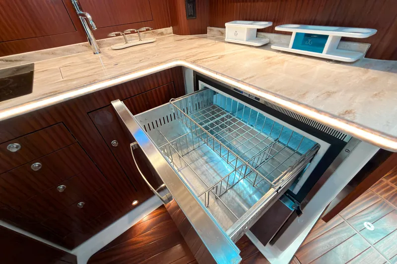 Slide: The Image of Luxurious 2021 Pursuit OS 385 Offshore yacht kitchen with open drawer and elegant wood finish. - 46