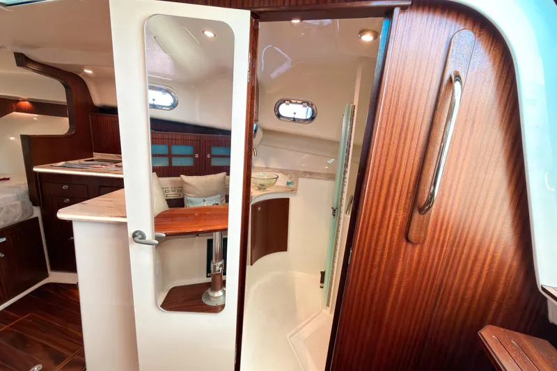 Slide: The Image of Luxurious interior of 2021 Pursuit OS 385 Offshore boat with wood accents and modern amenities. - 47