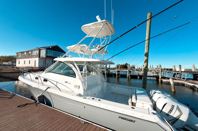Slide: The Image of 2021 Pursuit OS 385 Offshore boat docked at marina with clear blue sky. - 5
