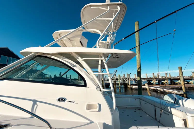 Slide: The Image of 2021 Pursuit OS 385 Offshore boat docked at marina under clear blue sky. - 56