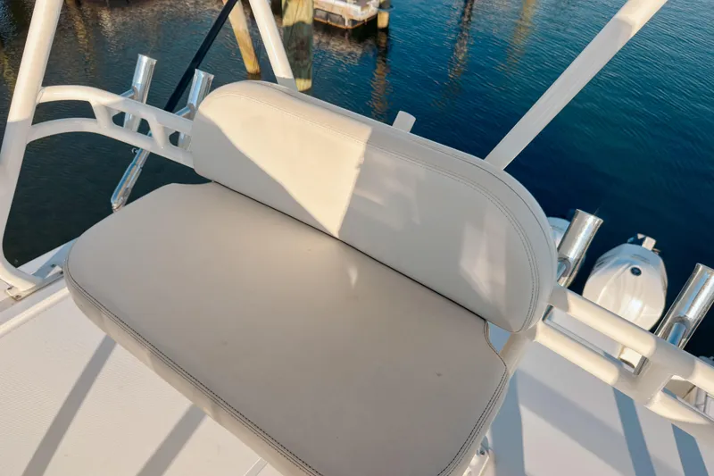 Slide: The Image of 2021 Pursuit OS 385 Offshore boat seat with rod holders, overlooking water. - 59