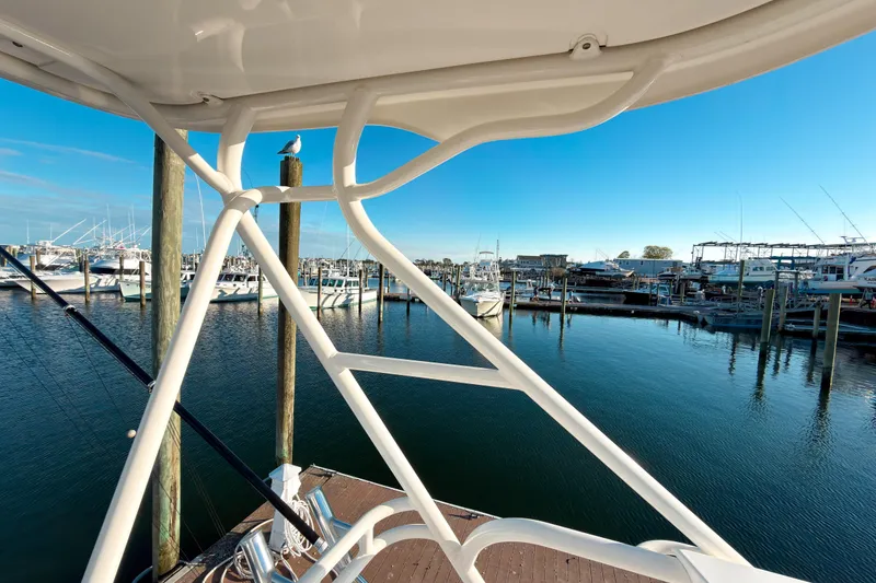 Slide: The Image of Marina view from 2021 Pursuit OS 385 Offshore boat, showcasing docked vessels and clear blue sky. - 60