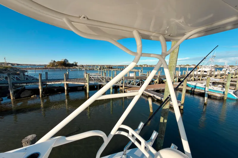 Slide: The Image of 2021 Pursuit OS 385 Offshore boat docked at a scenic marina with clear blue skies. - 61