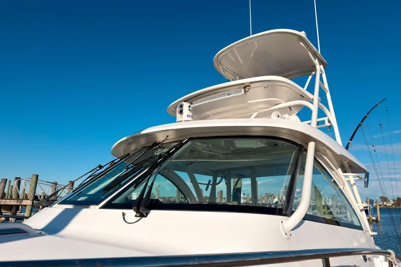 Slide: The Image of 2021 Pursuit OS 385 Offshore boat with clear blue sky background. - 62