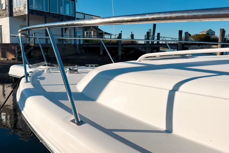 Slide: The Image of 2021 Pursuit OS 385 Offshore boat docked near waterfront homes. - 63