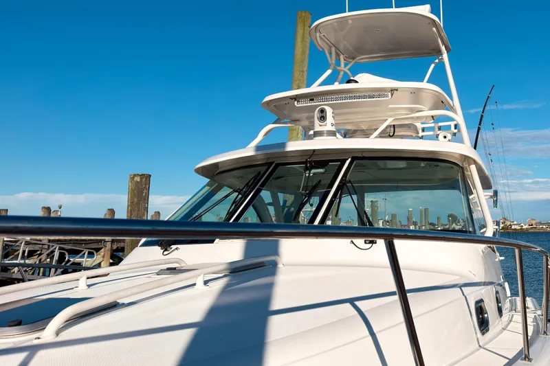 Slide: The Image of 2021 Pursuit OS 385 Offshore boat docked under clear blue sky. - 70
