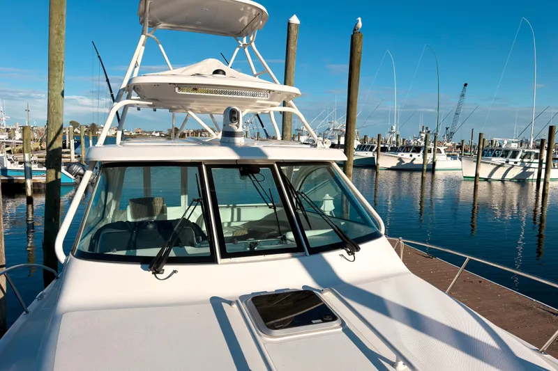 Slide: The Image of 2021 Pursuit OS 385 Offshore boat docked at marina under clear blue sky. - 72