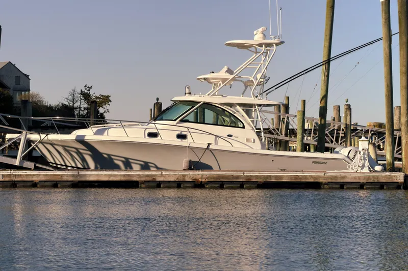 Slide: The Image of 2021 Pursuit OS 385 Offshore boat docked at marina under clear sky. - 77