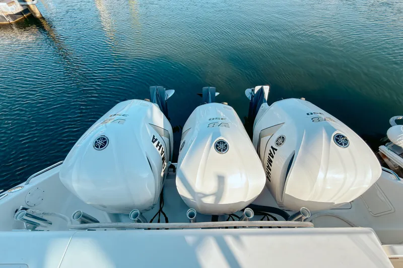 Slide: The Image of Triple Yamaha outboard engines on a 2021 Pursuit OS 385 Offshore boat. - 9