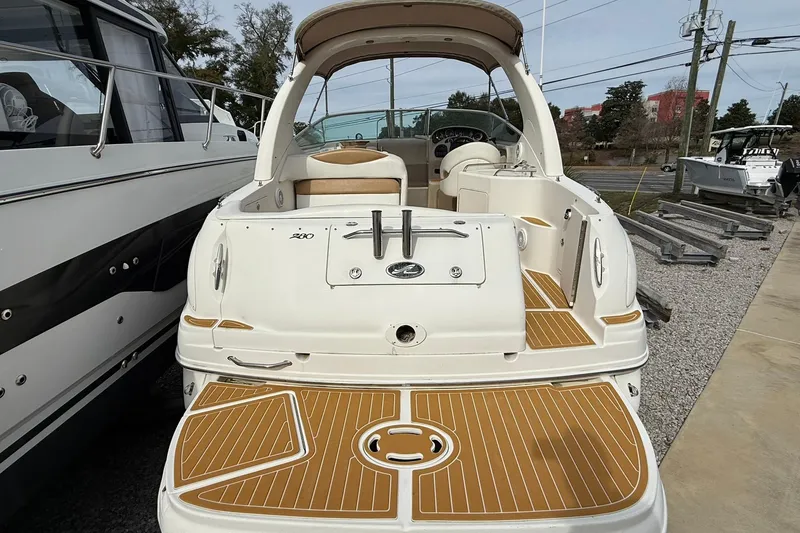 Slide: The Image of 2001 Sea Ray Sundancer 280 boat, rear view, docked with teak-style decking. - 2