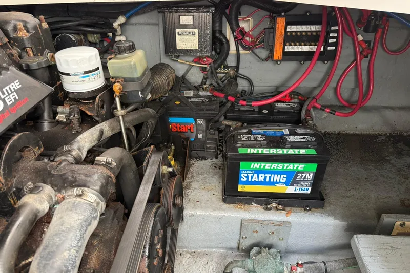 Slide: The Image of Engine compartment of a 2001 Sea Ray 280 Sundancer with marine battery and wiring. - 21