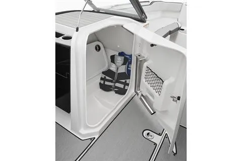 Slide: The Image of 2025 Yamaha Boats AR250 storage compartment with life jackets and netted door pocket. - 7