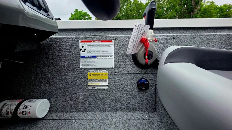 Slide: The Image of Interior of G3 Sportsman 1910 boat with control lever and safety warnings. - 13