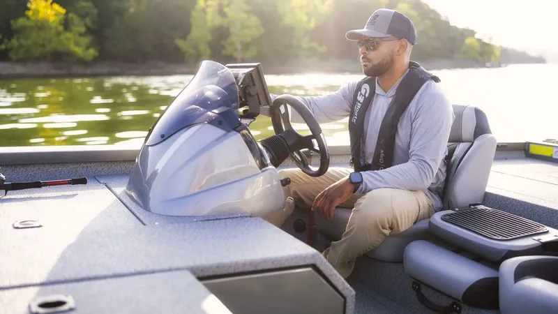 Slide: The Image of Man steering G3 Sportsman 1910 boat on sunny lake. - 22