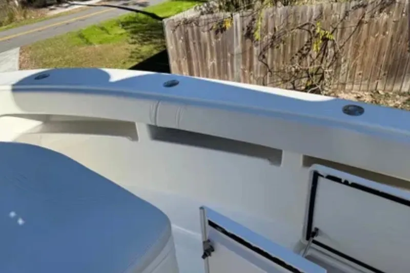 Slide: The Image of 2019 SeaVee 320B boat interior with open storage compartments and seating. - 12