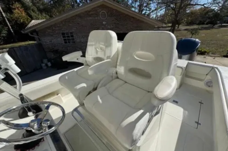 Slide: The Image of 2019 SeaVee 320B boat with white cushioned seats and steering wheel. - 14