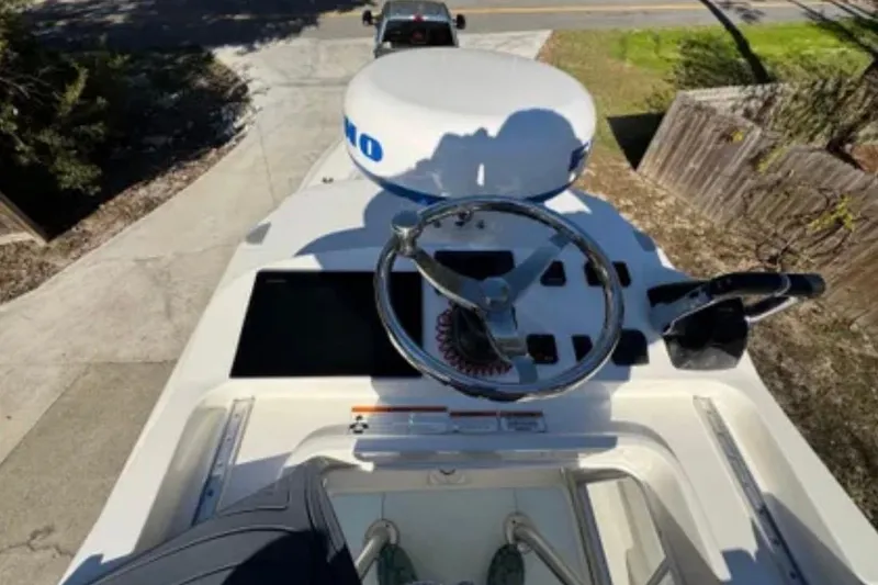 Slide: The Image of 2019 SeaVee 320B boat helm with steering wheel and controls, parked on driveway. - 18