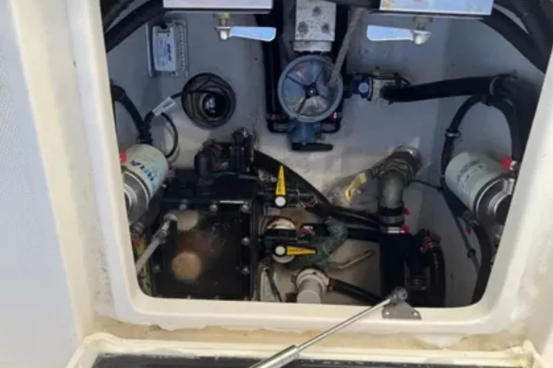 Slide: The Image of Engine compartment of a 2019 SeaVee 320B boat, showcasing mechanical components and wiring. - 25