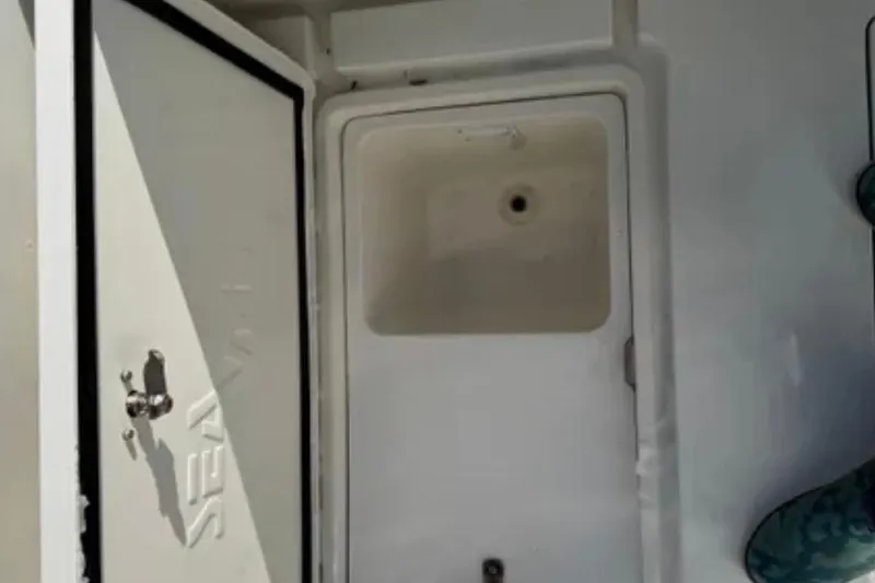 Slide: The Image of Open storage compartment on 2019 SeaVee 320B boat, showcasing interior details. - 26