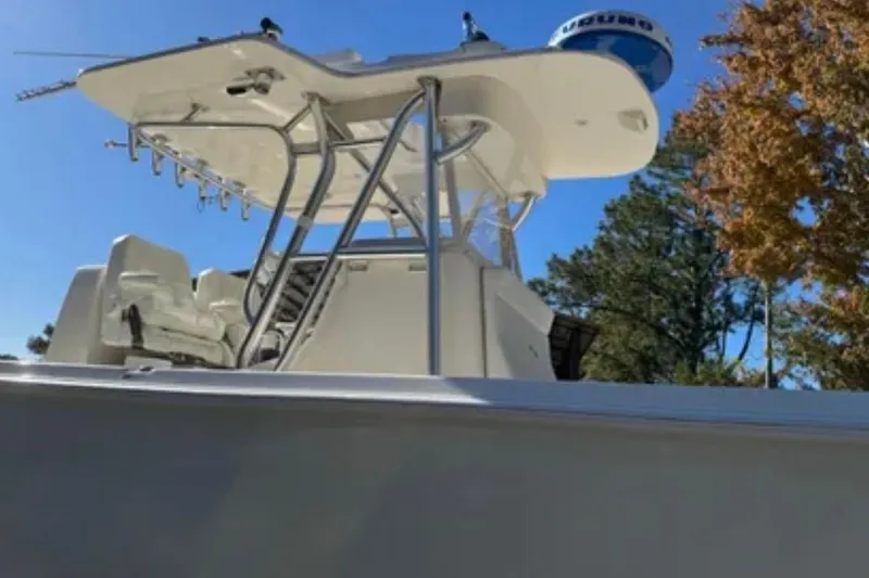 Slide: The Image of 2019 SeaVee 320B boat with T-top and seating, set against a clear blue sky. - 9