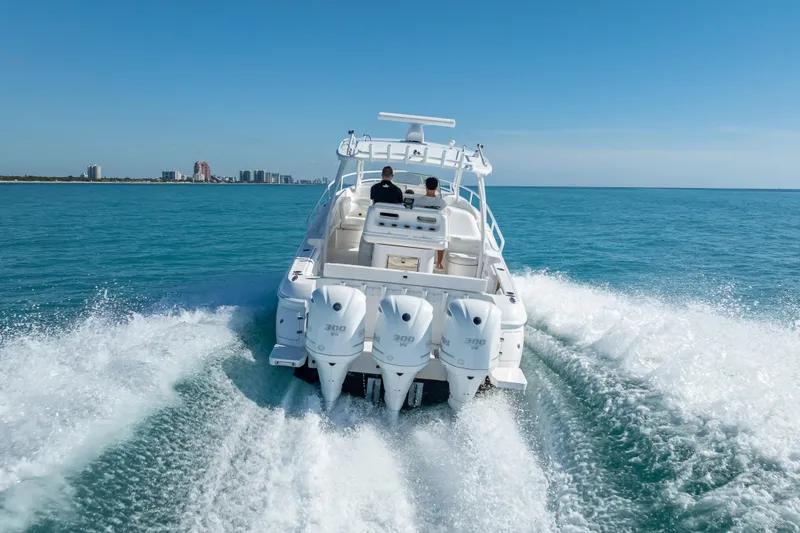 Slide: The Image of 2016 Intrepid 375 Center Console cruising on open water, city skyline in background. - 12