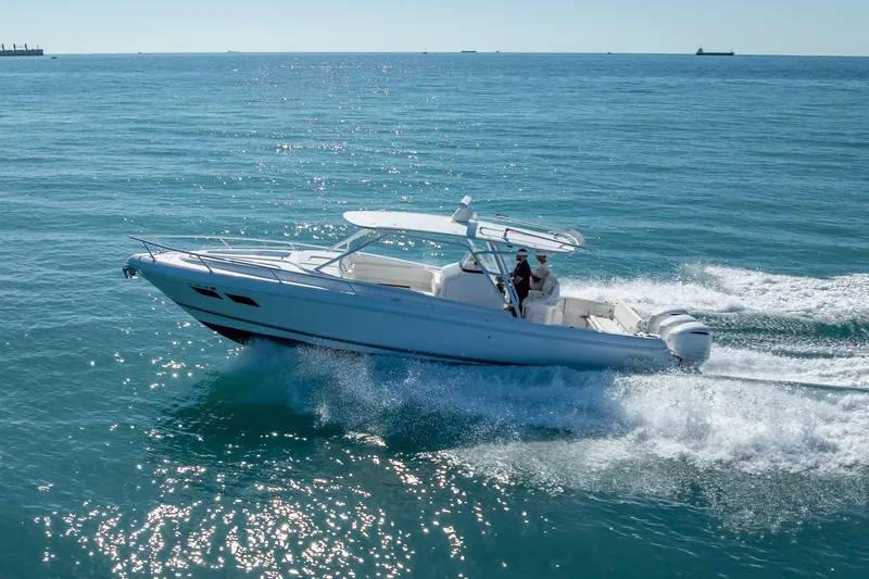 Slide: The Image of 2016 Intrepid 375 Center Console cruising on open water, showcasing sleek design and performance. - 19