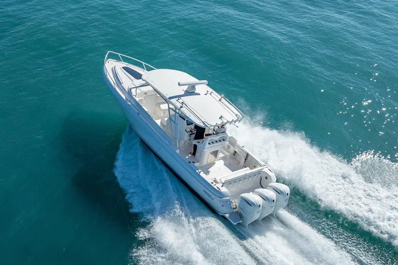 Slide: The Image of 2016 Intrepid 375 Center Console boat cruising on clear blue water. - 20