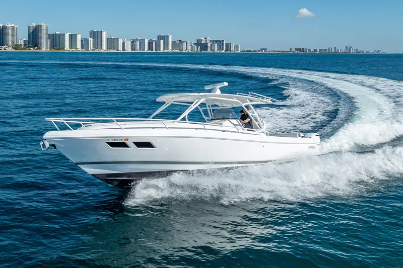 Slide: The Image of 2016 Intrepid 375 Center Console cruising on blue ocean near city skyline. - 21