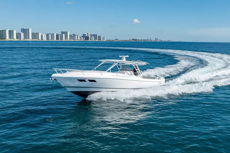 Slide: The Image of 2016 Intrepid 375 Center Console cruising on ocean near city skyline. - 22