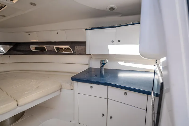 Slide: The Image of Interior of 2016 Intrepid 375 Center Console with seating and kitchenette. - 24