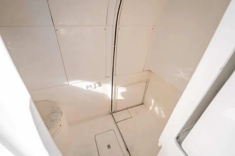 Slide: The Image of Interior cabin of 2016 Intrepid 375 Center Console boat, featuring clean white surfaces. - 27