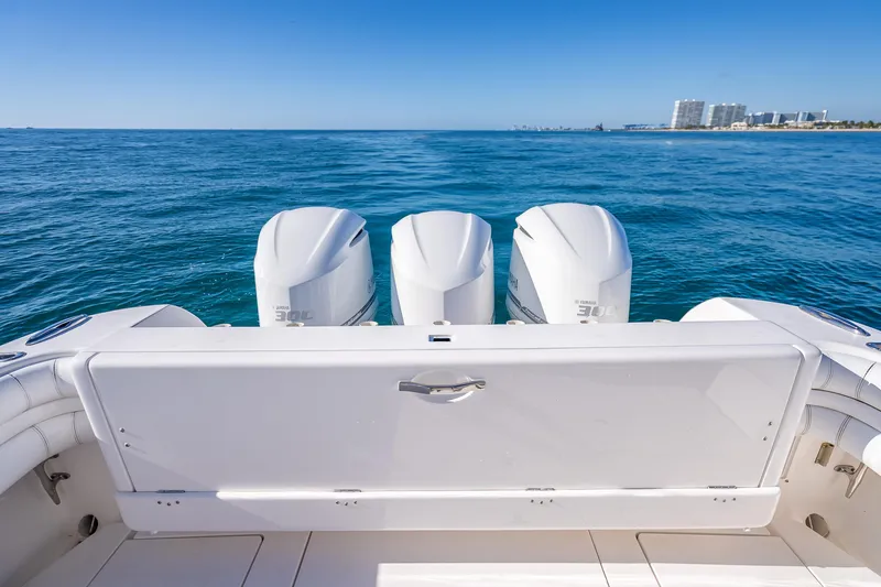 Slide: The Image of 2016 Intrepid 375 Center Console boat with triple Yamaha engines on open sea. - 33