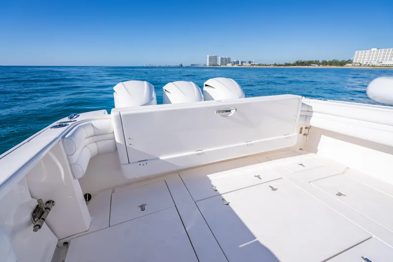 Slide: The Image of 2016 Intrepid 375 Center Console boat on open water, featuring spacious deck and triple engines. - 34