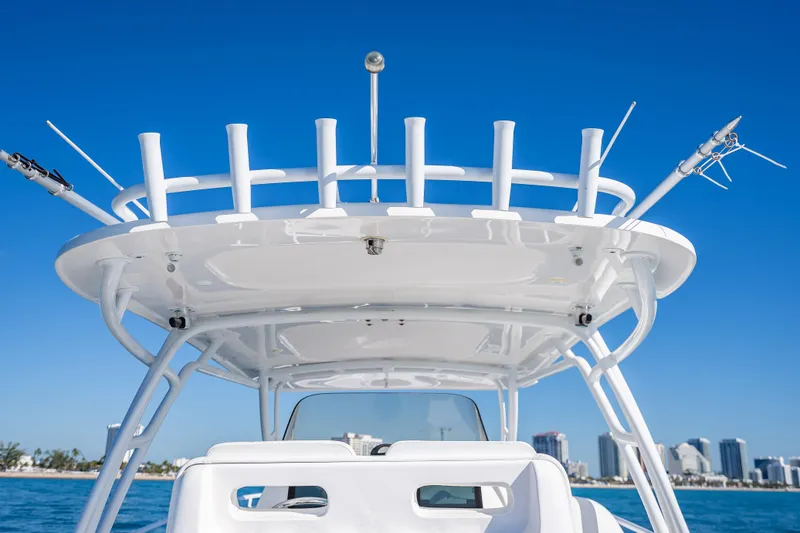 Slide: The Image of 2016 Intrepid 375 Center Console boat with rod holders against clear blue sky. - 36