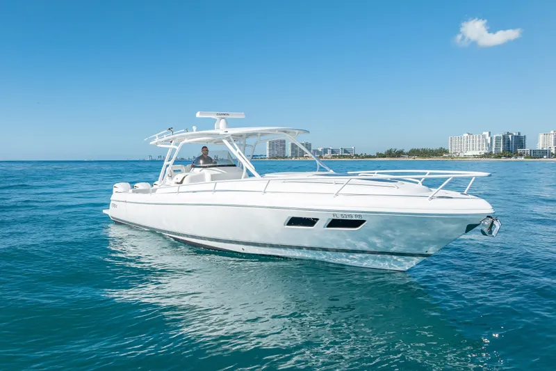 Slide: The Image of 2016 Intrepid 375 Center Console boat cruising on clear blue water. - 4