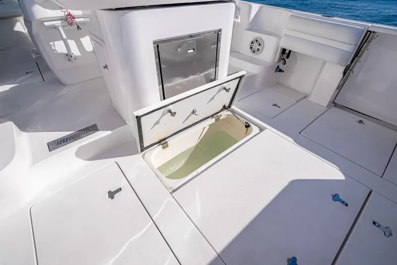 Slide: The Image of 2016 Intrepid 375 Center Console boat deck with open storage compartment. - 42