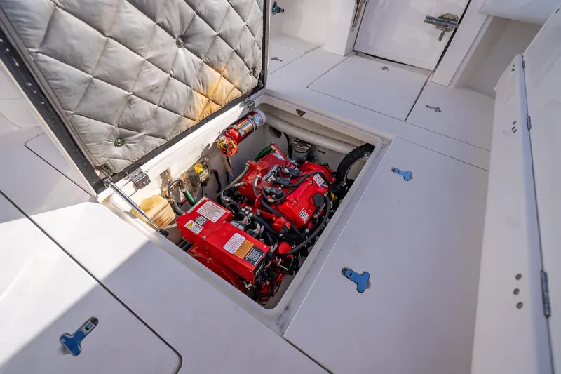 Slide: The Image of Engine compartment of a 2016 Intrepid 375 Center Console boat, featuring a red engine. - 43