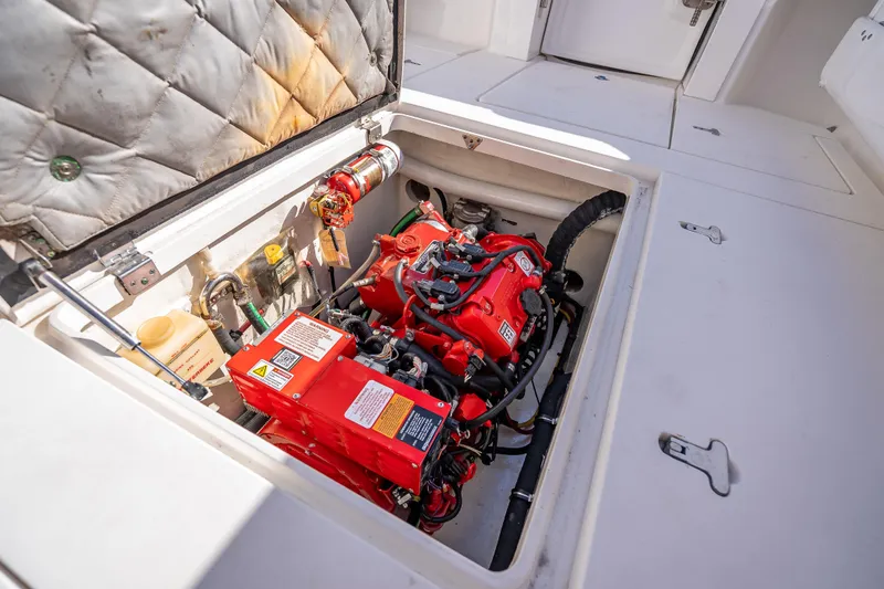 Slide: The Image of Engine compartment of a 2016 Intrepid 375 Center Console boat, showcasing red machinery. - 44