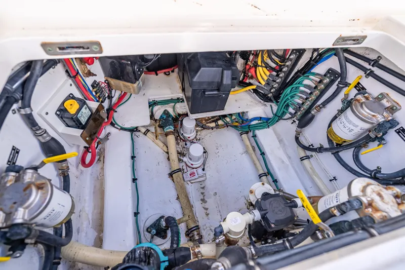 Slide: The Image of Engine compartment of a 2016 Intrepid 375 Center Console boat, showcasing wiring and components. - 46