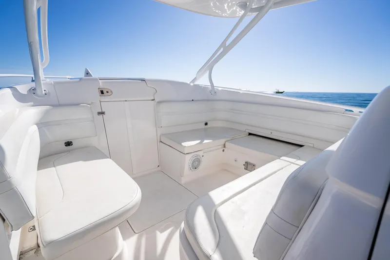 Slide: The Image of 2016 Intrepid 375 Center Console boat interior with white seating and ocean view. - 54
