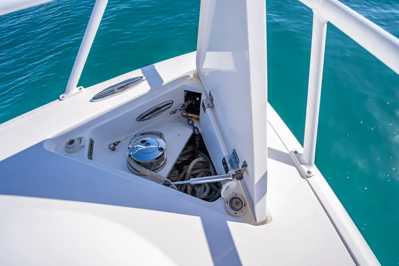 Slide: The Image of Anchor storage compartment on 2016 Intrepid 375 Center Console boat, with turquoise water background. - 55