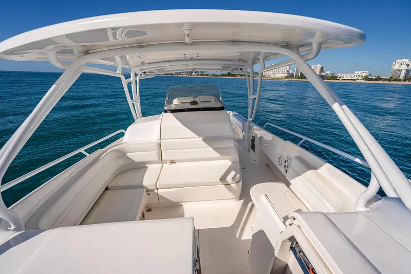 Slide: The Image of 2016 Intrepid 375 Center Console boat on open water, featuring spacious seating and sleek design. - 56